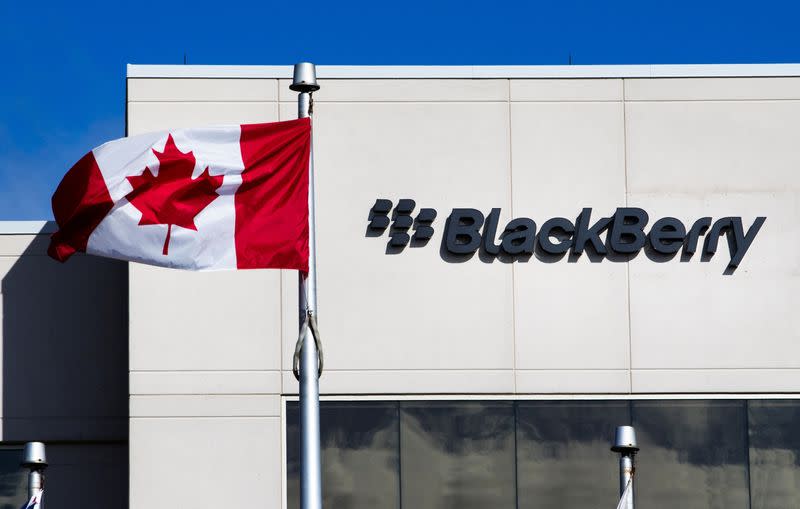 FILE PHOTO: A Canadian flag waves in front of a Blackberry logo at the Blackberry campus in Waterloo