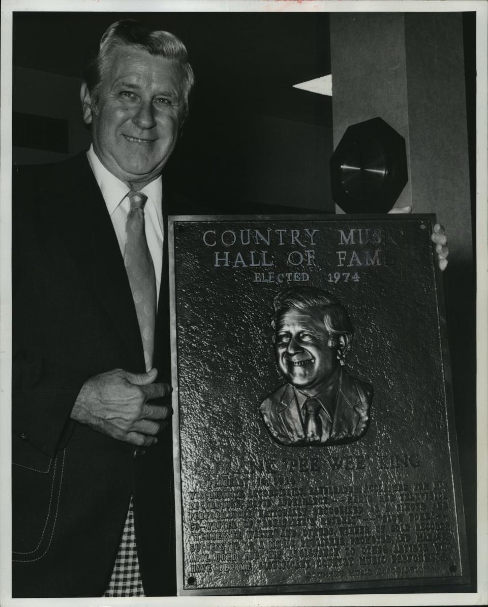 Pee Wee King holds his plaque after his induction into the Country Music Hall of Fame in 1974. King, born Julius Frank Anthony Kuczynski in Milwaukee, was an important figure in country music starting in the late 1930s; Ken Burns' new documentary series "Country Music" puts a spotlight on his contributions. This photo was in the Jan. 12, 1975, Milwaukee Journal.