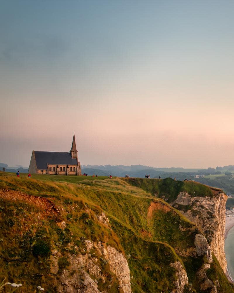 View on the the falaise d’Aval in Etretat, Cote d’Albatre, Normandy, France,at sunset. Also seen the Chapel Notre-Dame de la Garde.