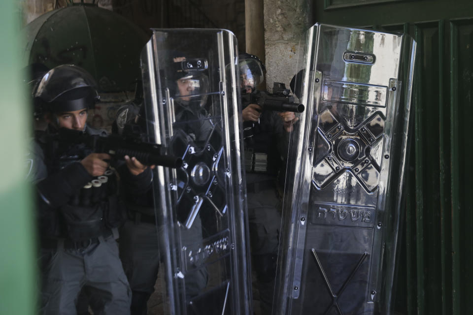 Israeli security forces take positions during clashes with Palestinians in front of the Dome of the Rock Mosque at the Al Aqsa Mosque compound in Jerusalem's Old City, Friday, June 18, 2021. (AP Photo/Mahmoud Illean)