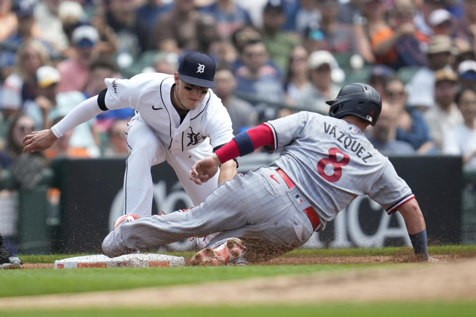 Minnesota Twins' Christian Vazquez (8) slides into third base safely ahead of the tag from Detroit Tigers third baseman Nick Maton (9) in the third inning of a baseball game, Sunday, June 25, 2023, in Detroit. (AP Photo/Paul Sancya)