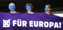 People, with faces painted like a European flag, arrive for a demonstration in Berlin, Germany, Sunday, May 19, 2019. People across Europe attend demonstrations under the slogan 'A Europe for All - Your Voice Against Nationalism'. The banner reads 'For Europe". (AP Photo/Markus Schreiber)