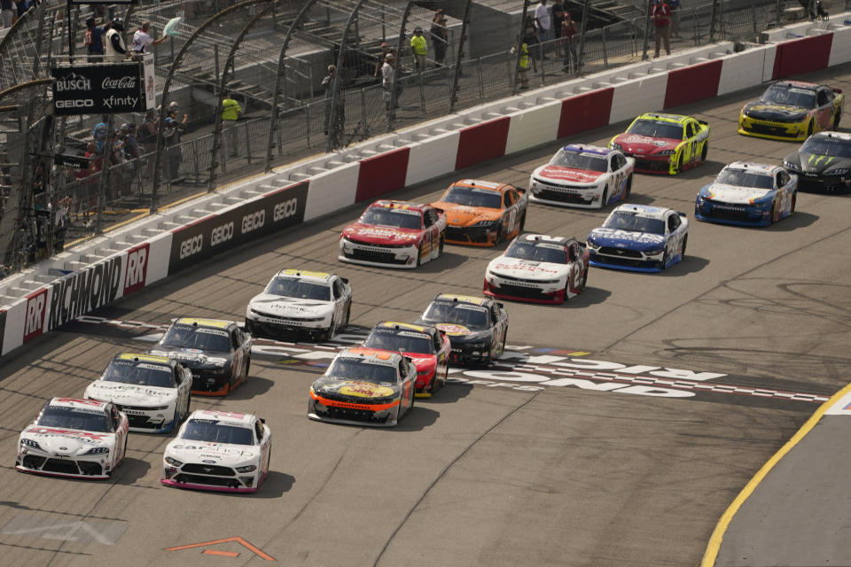 Harrison Burton (20) and Austin Cindric (22) lead the field at the start of the NASCAR Xfinity auto race in Richmond, Va., Saturday, Sept. 11, 2021. (AP Photo/Steve Helber)