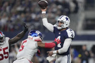 Dallas Cowboys quarterback Dak Prescott (4) throws a pass as he is pressured by New York Giants defensive end Kayvon Thibodeaux (5) during the first half of an NFL football game Thursday, Nov. 24, 2022, in Arlington, Texas. (AP Photo/Tony Gutierrez)