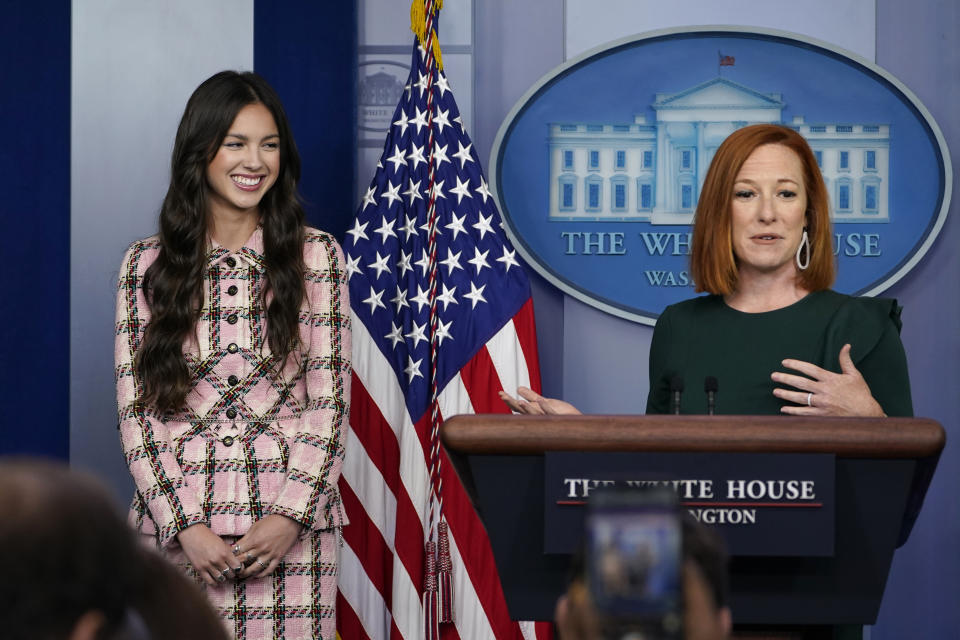 White House press secretary Jen Psaki, right, speaks about teen pop star Olivia Rodrigo, left, during the daily briefing at the White House in Washington, Wednesday, July 14, 2021. Rodrigo is at the White House to film a video to promote vaccines. (AP Photo/Susan Walsh)