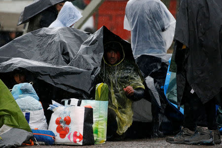 Kurdish migrants from Iran take shelter from the rain, after the dismantling of a camp in Calais, France, January 10, 2019. Picture taken January 10, 2019. REUTERS/Pascal Rossignol