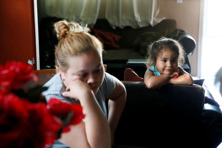 Karla Rojas, 26, (L) is interviewed about lead paint that was found in her brother's home while she was living there with her three-year old daughter Kendra Nicole Rojas (R), in the Historic South Central neighborhood of Los Angeles, California, United States April 5, 2017. REUTERS/Danny Moloshok