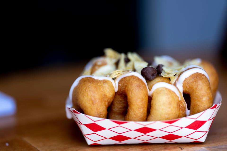 A view of The Taste dish from Trolley Donuts, which is donuts with vanilla drizzle, salted caramel drizzle, chocolate chips and crushed potato chips at Taste of Cincinnati 2023.