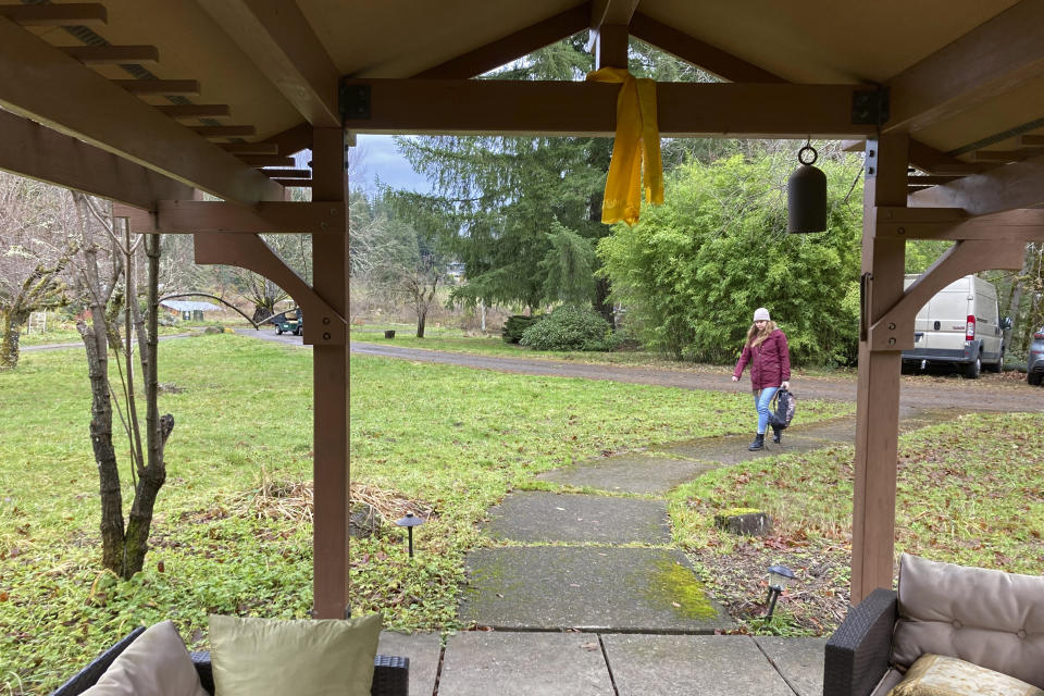 A participant arrives for a psilocybin training session at a woodsy venue near Damascus, Ore., on Dec. 2, 2022. Psilocybin facilitator students are being trained in how to accompany patients tripping on psilocybin as Oregon prepares to become the first state in America to offer controlled use of the psychedelic mushroom to the public. (AP Photo/Andrew Selsky)