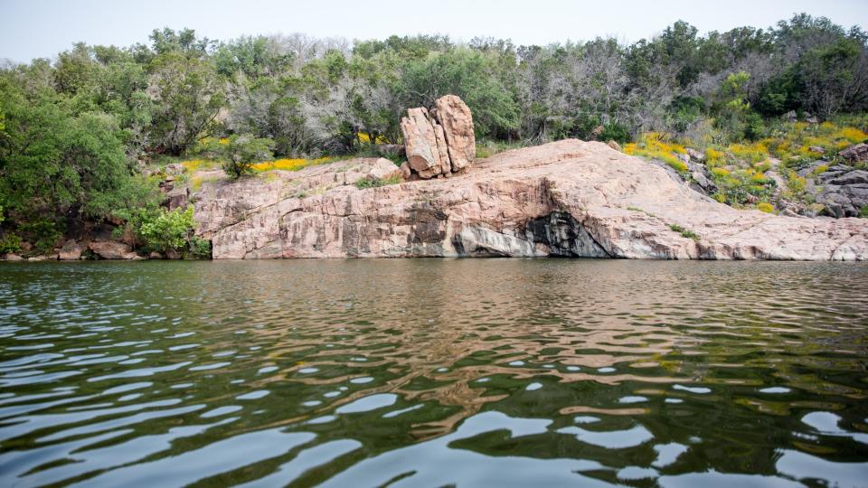 Inks Lake State Park view across the lake to a rock formation