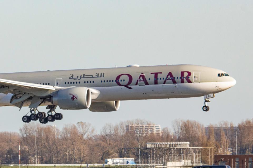 Qatar Airways Boeing 777-300 aircraft as seen on final approach flying and landing next to the highway road in Amsterdam Schiphol AMS EHAM airport in the Netherlands, arriving from Hamad International Airport DOH OTHH the Qatari capital. The wide body long haul airplane, a Boeing B777 or 773 has the registration A7-BEU and is powered by 2x GE jet engines. Qatar QTR QR is the state own national flag carrier of the State of Qatar. The airline is member of Oneworld aviation alliance. Qatar didn't stop flying during the first or the second wave of the epidemic despite the fact that the world passenger traffic declined during the coronavirus covid-19 pandemic with the industry struggling to survive. Amsterdam, Netherlands on November 18, 2020 (Photo by Nicolas Economou/NurPhoto via Getty Images)