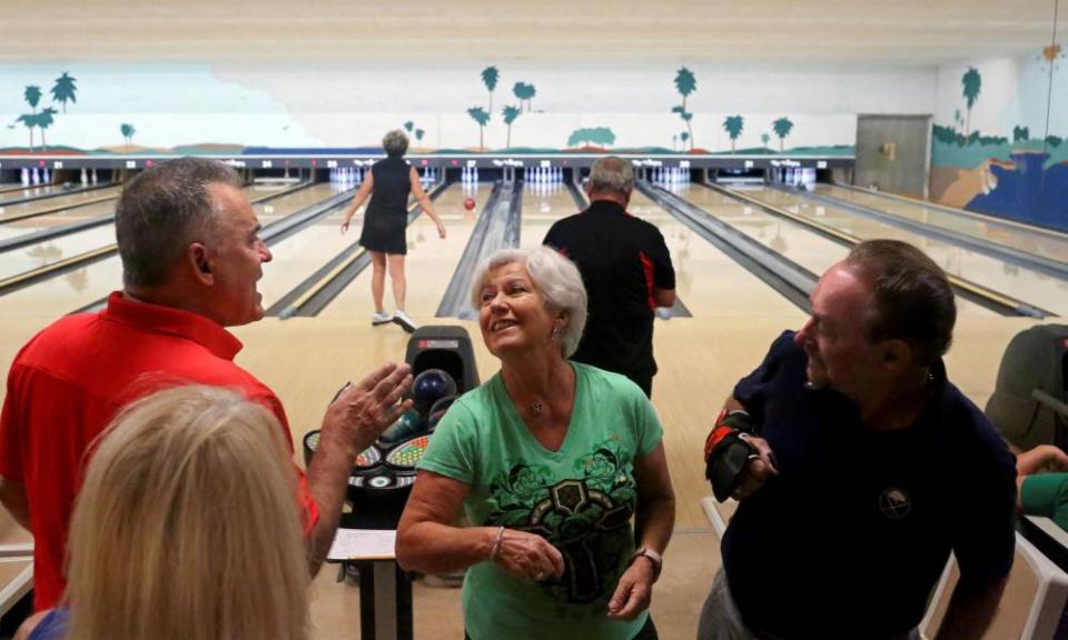 People elbow bump while bowling at Spanish Springs Town Square, in The Villages, Florida, in March.