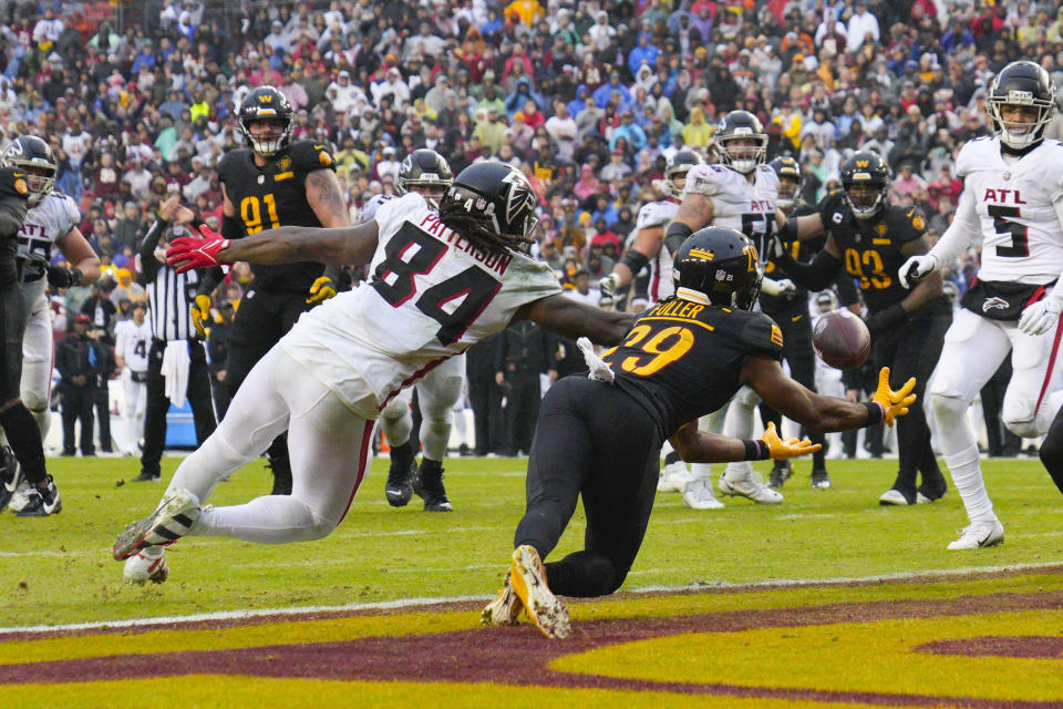 Washington Commanders cornerback Kendall Fuller (29) makes an interception against Atlanta Falcons running back Cordarrelle Patterson (84) during the second half of an NFL football game, Sunday, Nov. 27, 2022, in Landover, Md. Washington won the game 13-19. (AP Photo/Jessica Rapfogel)