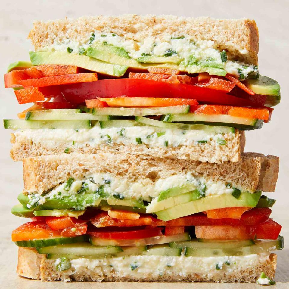 <p>This loaded cucumber-and-avocado sandwich is filled with creamy avocado and crispy cucumbers. Ricotta cheese mixed with extra-sharp Cheddar adds flavor while sliced red peppers offer a splash of color.</p> <p> <a href="https://www.eatingwell.com/recipe/7964563/loaded-cucumber-avocado-sandwich/" rel="nofollow noopener" target="_blank" data-ylk="slk:View Recipe;elm:context_link;itc:0;sec:content-canvas" class="link ">View Recipe</a></p>