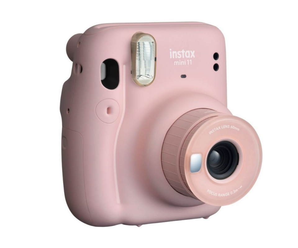 Fujifilm's Instax mini 11 film camera in pink against a white backdrop.