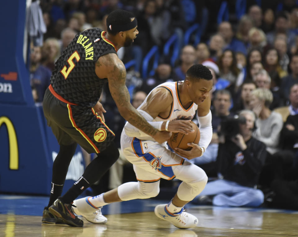 Atlanta Hawks’ Malcolm Delaney, left, tries to get the ball away from Oklahoma City Thunder’s Russell Westbrook, right, in the third quarter of an NBA basketball game in Oklahoma City, Friday, Dec. 22, 2017. (AP Photo/Kyle Phillips)