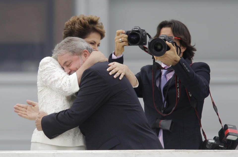 FILE - Brazil's outgoing President Luiz Inacio Lula da Silva embraces incoming President Dilma Rousseff after placing the presidential sash on her at the Planalto palace in Brasilia, Brazil, Jan. 1, 2011. (AP Photo/Silvia Izquierdo, File)