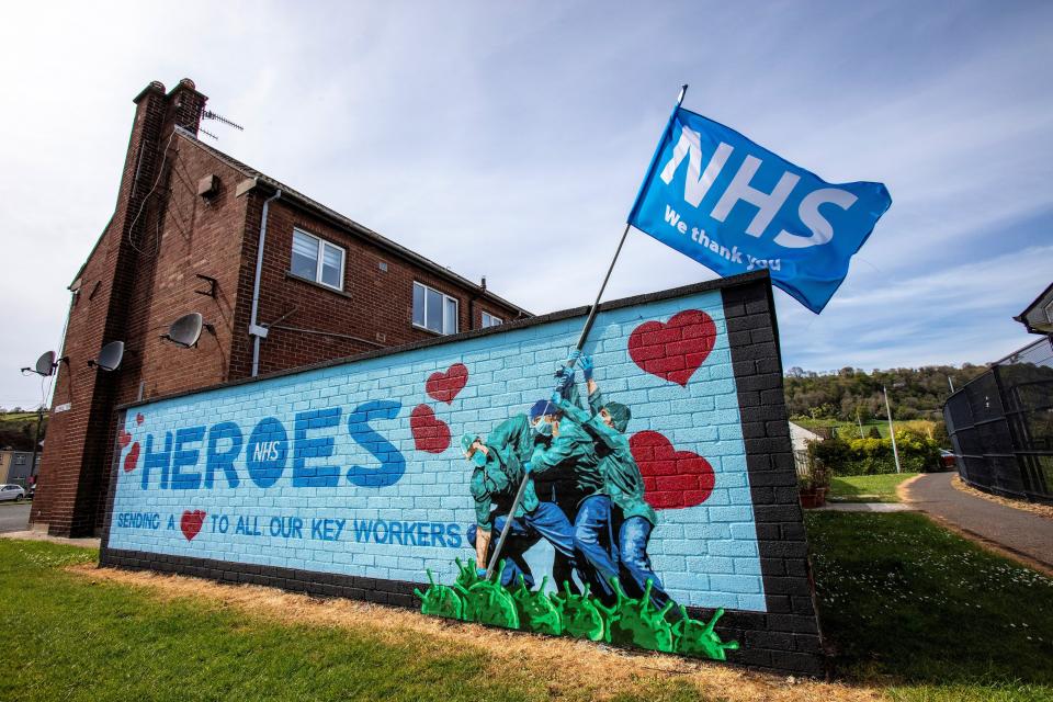 Street art graffiti paying tribute to the NHS, (National Health Service), is pictured on a wall in Glynn, north of Belfast on May 5, 2020. - The number of people killed by the coronavirus in the UK stands at 32,313, according to official figures on May 5 2020, the second highest death toll in the world. Figures from the Office for National Statistics showed Britain had now overtaken Italy, which has reported 29,029 fatalities, and now only stands behind the US with 68,700 deaths, the largest single-country toll. (Photo by Paul Faith / AFP) (Photo by PAUL FAITH/AFP via Getty Images)