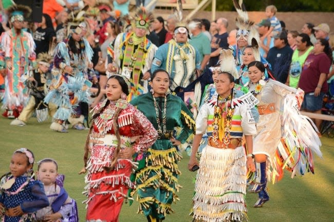 Dancers enter the Cherokee Cultural Grounds arena during the grand entry of the 2018 Cherokee National Holiday Intertribal Powwow.