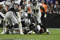 Las Vegas Raiders defensive end Carl Nassib (94) forces a fumble by Baltimore Ravens quarterback Lamar Jackson (8) during overtime in an NFL football game, Monday, Sept. 13, 2021, in Las Vegas. (AP Photo/David Becker)