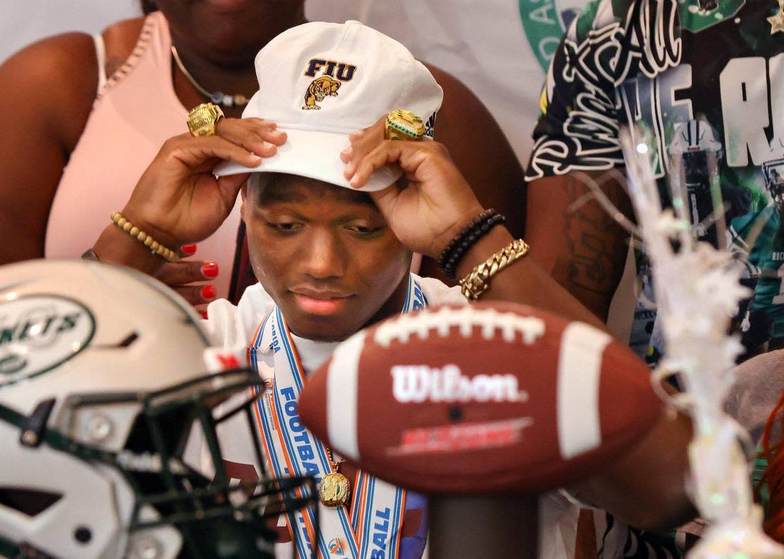 Quarterback Keyone Jenkins puts on his cap after deciding to sign with FIU. On Wednesday, December 21, 2022 Miami Central held its signing day for their senior players as the football players announced the colleges they plan to play for after graduation.