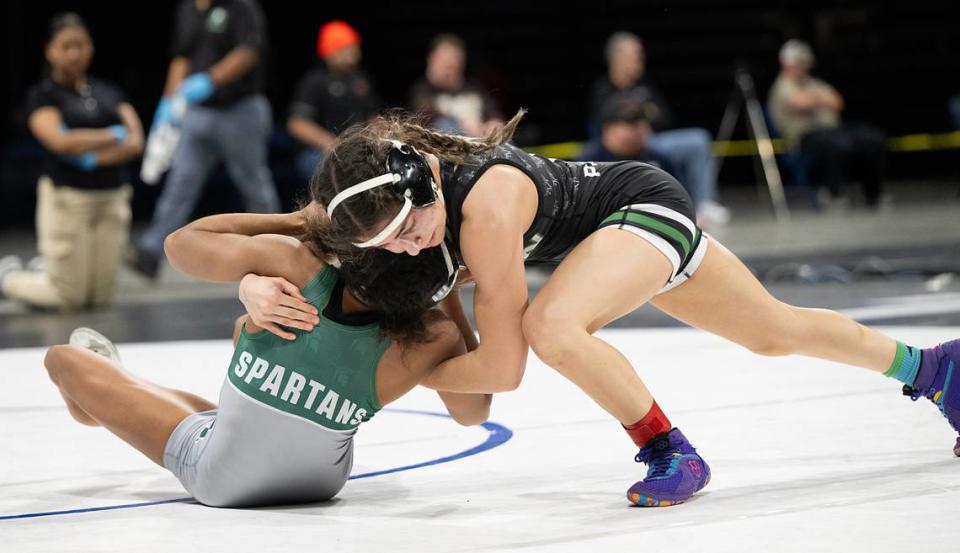 Pitman’s Lexie Capote of Pitman, attacks Jazmine Turner of Grace Davis in the 105-pound championship match during the Sac-Joaquin Section Masters Wrestling Championships at Stockton Arena in Stockton, Calif., Saturday, Feb. 17, 2024. Capote won the match 7-3.