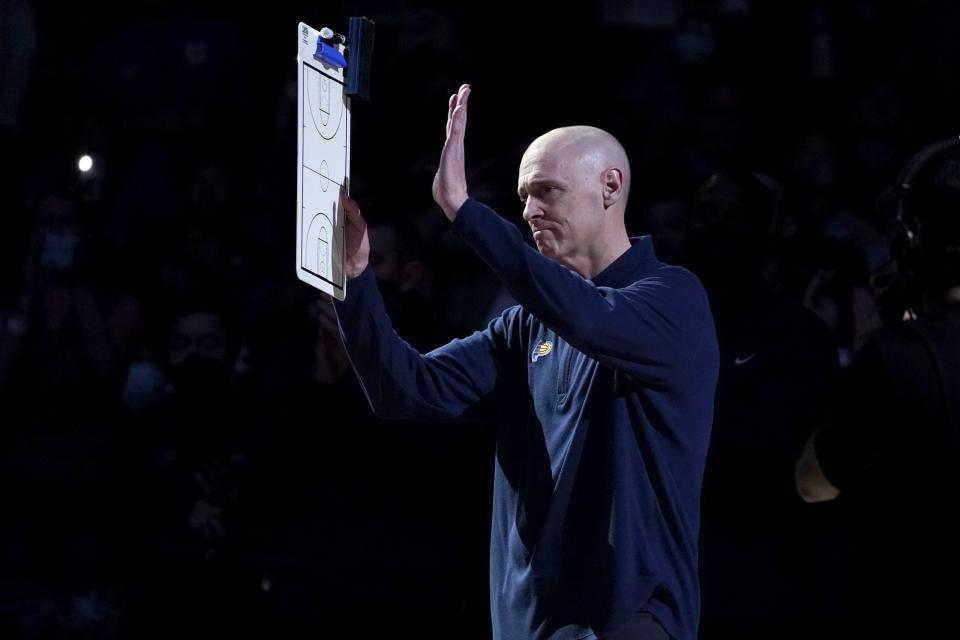 Indiana Pacers head coach Rick Carlisle acknowledges cheers from fans after a video tribute honoring Carlisle's time in Dallas was showed on the large in-house video screen before the first half of an NBA basketball game against the Dallas Mavericks in Dallas, Saturday, Jan. 29, 2022. (AP Photo/Tony Gutierrez)