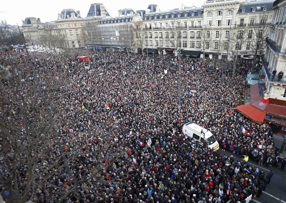 A general view shows an ambulance surrounded by hundreds of thousands of people gathering on the Place de la Republique to attend the solidarity march in the streets of Paris