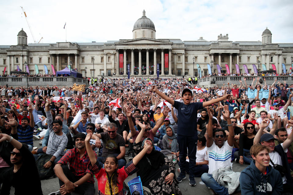 Fans react as they watch a big screen in the Fanzone at Trafalgar Square during the Cricket World Cup Final between New Zealand and England at the ICC Fanzone, London.