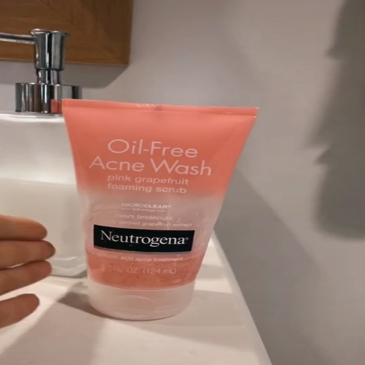 Neutrogena Oil-Free Acne Wash pink grapefruit foaming scrub on a sink