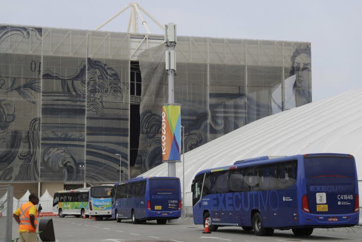 Buses arrive at the Olympic Aquatic Stadium (AP)