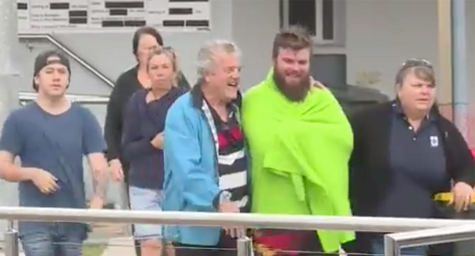 Members of the family that were on the boat are seen walking away.