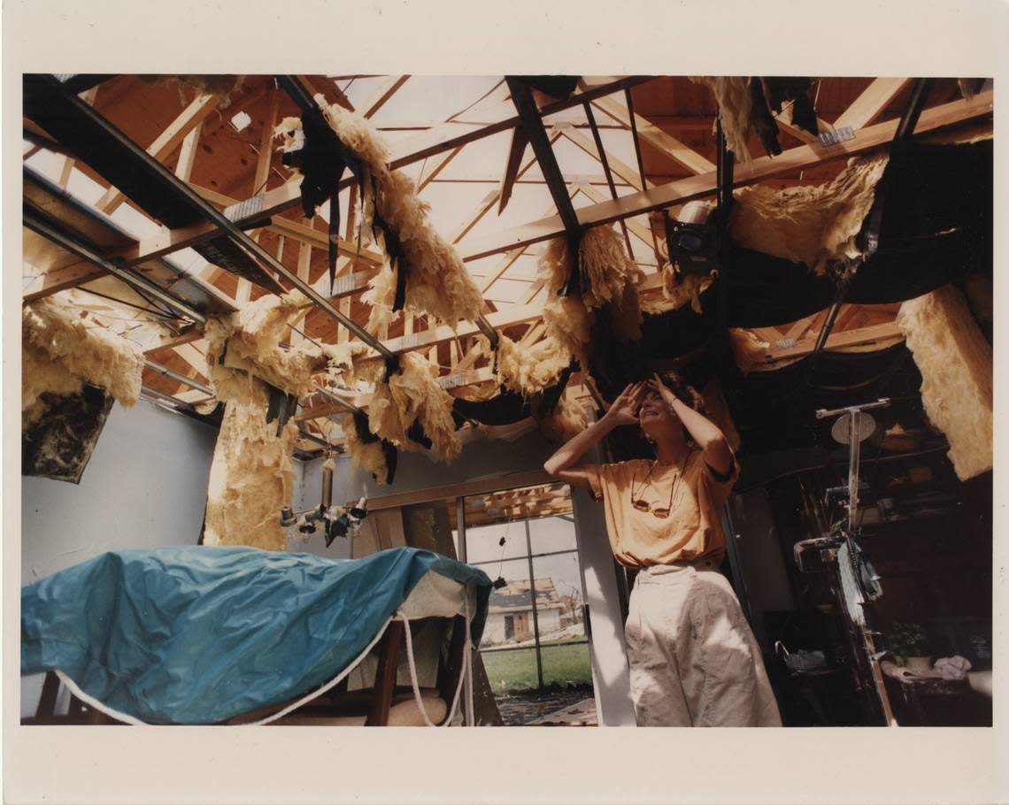 In this file photo from August 1992, from the Miami Herald-published book about Hurricane Andrew, “The Big One,” South Miami-Dade resident Sharon Hench looked up at the huge holes in the roof of her Country Walk home. During the storm, she and her husband, Michael, dashed from room to room to survive.