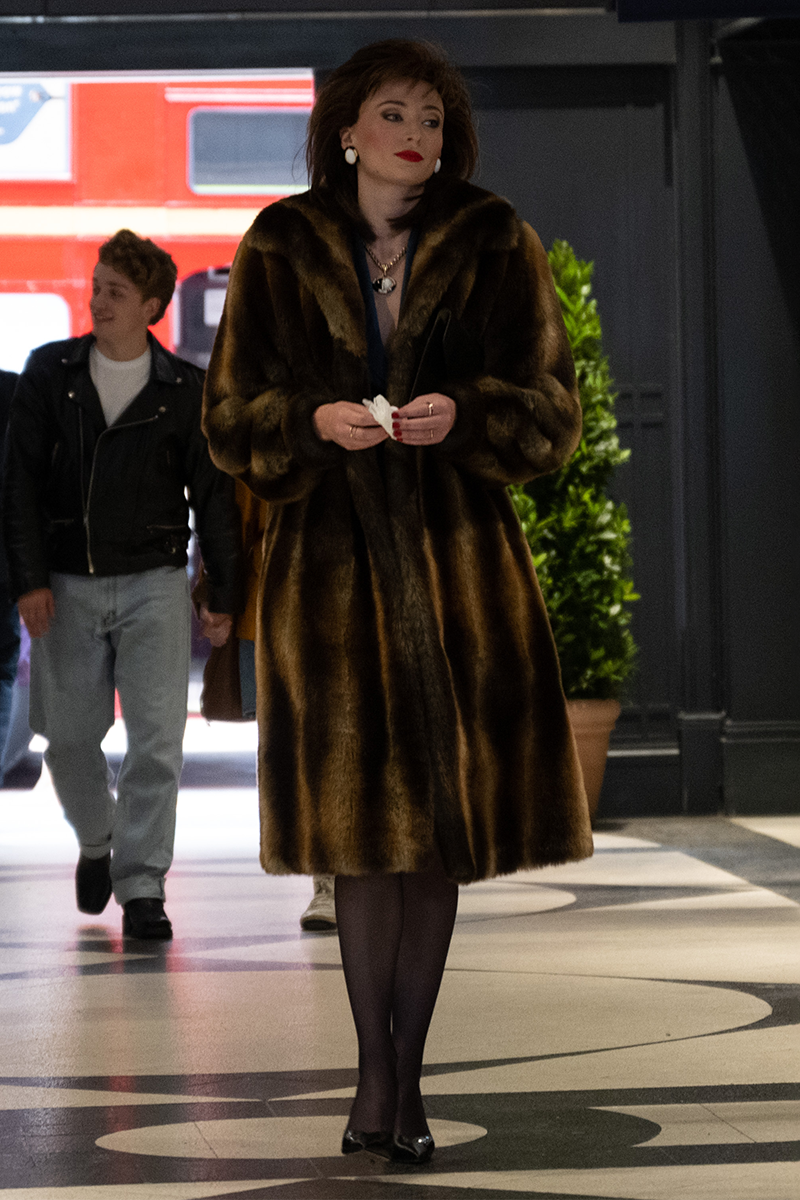 sophie turner joan outfits faux fur coat