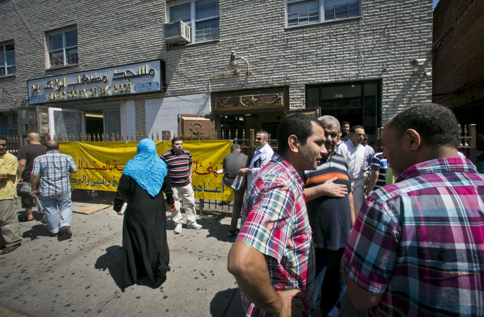 FILE - In this Aug. 16, 2013, file photo, visitors socialize after a Jumu'ah prayer service outside the Islamic Society of Bay Ridge and mosque in the Brooklyn borough of New York. The New York Police Department targeted the mosque as a part of a terrorism enterprise investigation beginning in 2003, spying on it for years. On Tuesday, April 15, 2014, the NYPD confirmed that it has disbanded the special unit that operated that surveillance program. (AP Photo/Bebeto Matthews, File)