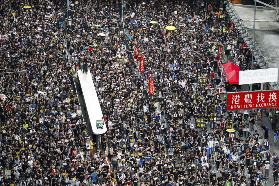 Protesters take part in a march on a street in Hong Kong, Sunday, July 21, 2019. Thousands of Hong Kong protesters marched from a public park to call for an independent investigation into police tactics. (AP Photo/Vincent Yu)