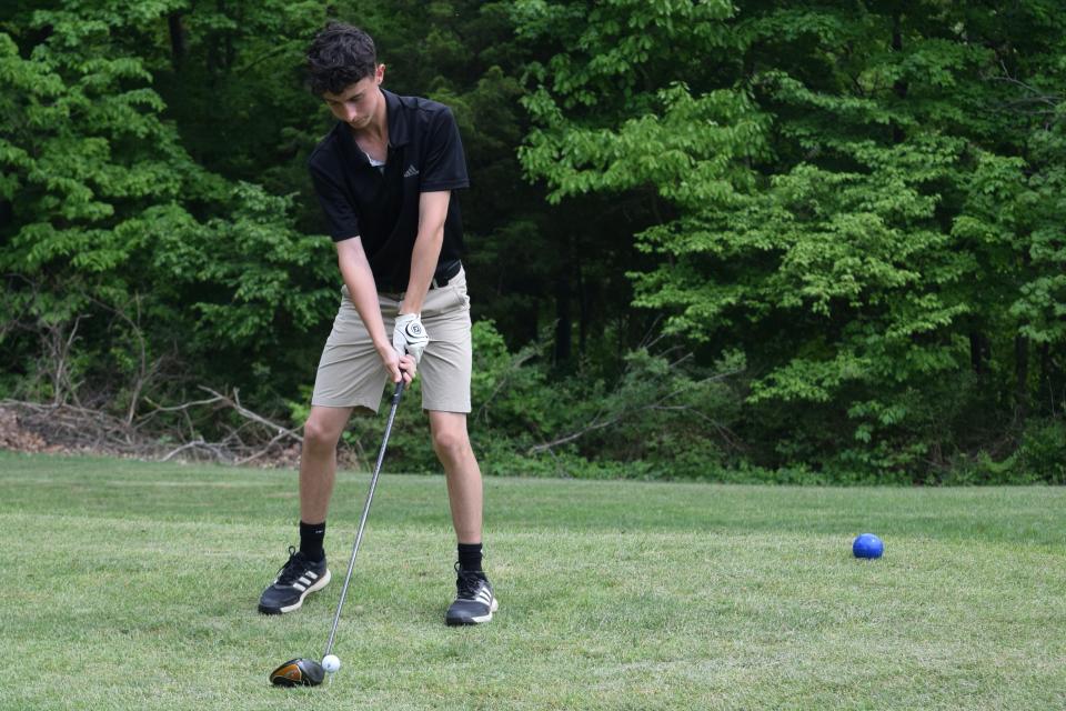 Bloomington North senior Charlie Nicholson prepares to tee off on the first hole at Cascades Golf Course during the Cougars' dual match against Bloomington South. The match was later suspended due to inclement weather. (Seth Tow/Herald-Times)