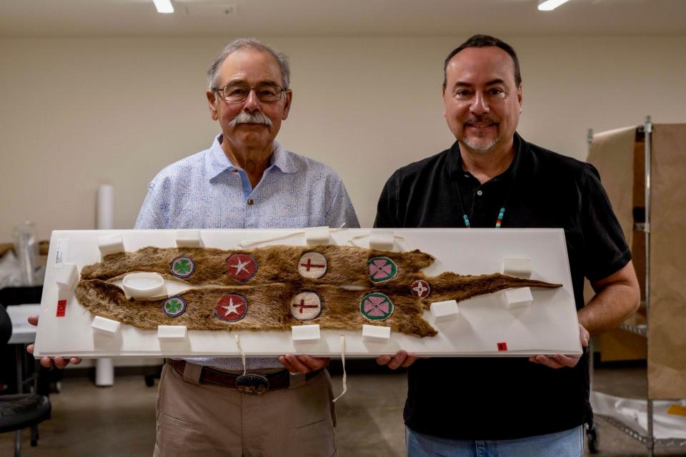 James Pepper Henry, director and CEO for the First Americans Museum, right, poses for a photo with fellow Kaw Nation citizen William Mehojah. They are holding an otter collar that belonged to Mehojah's grandfather.