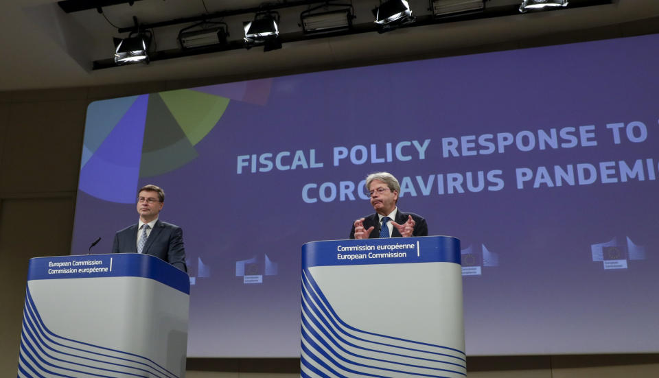 European Commissioner for Economy Paolo Gentiloni, right, and European Commissioner for an Economy that Works for the People Valdis Dombrovskis, participate in a media conference on the Fiscal Policy Response to the Coronavirus Pandemic at EU headquarters in Brussels, Wednesday, March 3, 2021. (Olivier Hoslet, Pool via AP)