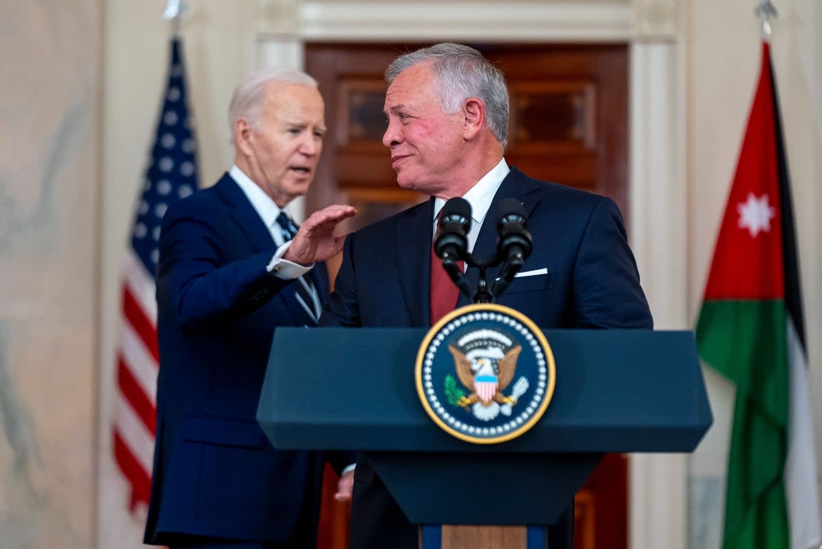 President Joe Biden and Jordan's King Abdullah II speak in the Cross Hall of the White House on Monday (AP)