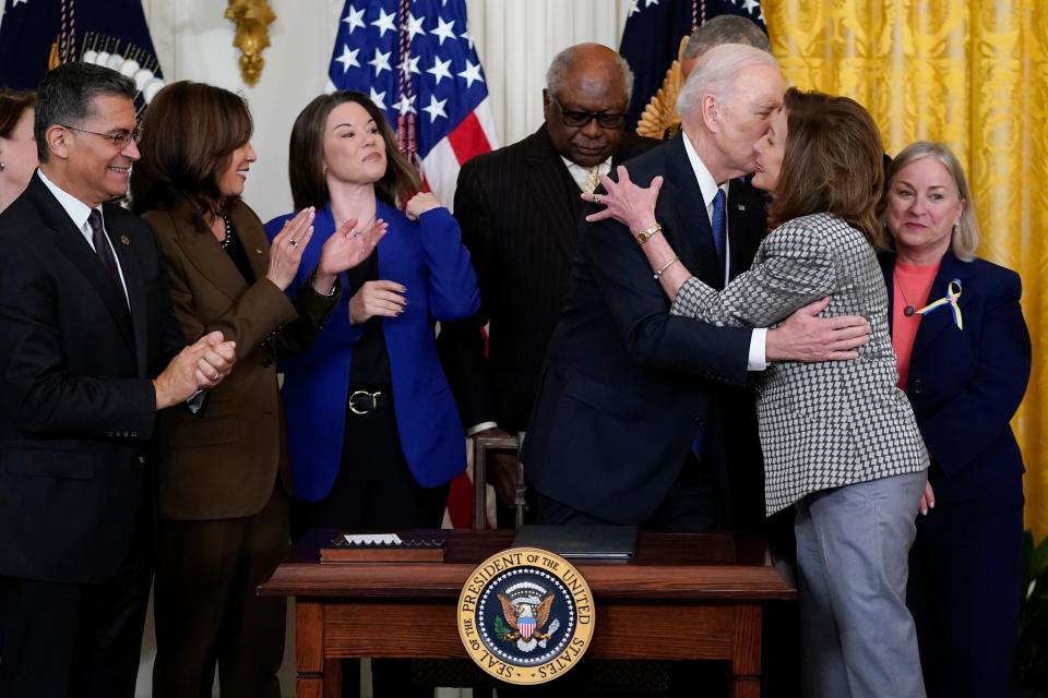 President Joe Biden kisses House Speaker Nancy Pelosi of Calif., during an Affordable Care Act event in the East Room of the White House in Washington (AP)