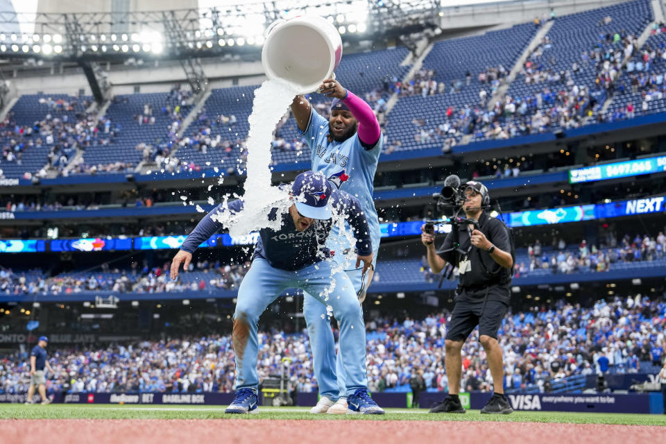 Toronto Blue Jays' Ernie Clement is doused by Vladimir Guerrero Jr. after the team's win over the Washington Nationals in a baseball game in Toronto on Wednesday, Aug. 30, 2023. (Andrew Lahodynskyj/The Canadian Press via AP)