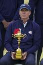 Team USA captain Steve Stricker holds the Ryder Cup as they pose for a picture on the 18th hole during a practice day at the Ryder Cup at the Whistling Straits Golf Course Wednesday, Sept. 22, 2021, in Sheboygan, Wis. (AP Photo/Charlie Neibergall)