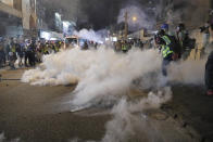 Tear gas fills the street as protesters continue to battle with police on the streets of Hong Kong on Saturday, Sept. 21, 2019. Protesters in Hong Kong threw gasoline bombs and police fired tear gas Saturday in renewed clashes over anti-government grievances (AP Photo/Kin Cheung)