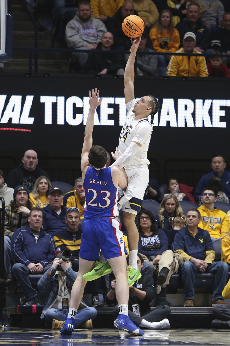 West Virginia forward Patrick Suemnick (24) shoots over Kansas forward Parker Braun (23) during the first half of an NCAA college basketball game on Saturday, Jan. 20, 2024, in Morgantown, W.Va. (AP Photo/Kathleen Batten)