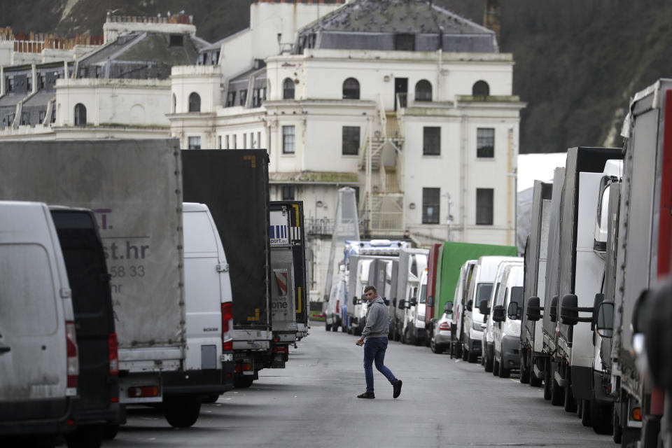 Goods vans wanting to return to Europe are parked along the seafront whilst the Port of Dover remains closed, in Dover, southern England, Tuesday, Dec. 22, 2020. Trucks waiting to get out of Britain are backed up for miles and people were left stranded at airports as dozens of countries around the world slapped tough travel restrictions on the U.K. because of a new and seemingly more contagious strain of the coronavirus in England.(AP Photo/Kirsty Wigglesworth)