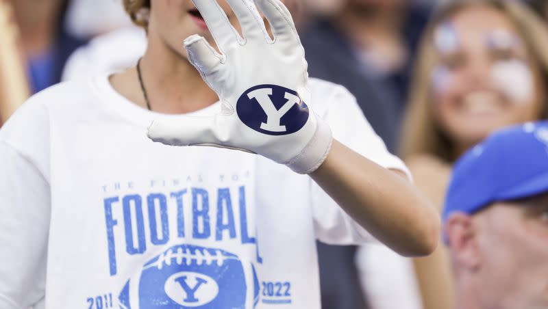 A fan shows his BYU glove for photo during a football game at LaVell Edwards Stadium in Provo on Saturday, Oct. 15, 2022.