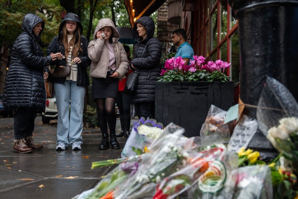 Fans gather outside of the 'Friends' building in NYC after Matthew Perry's death