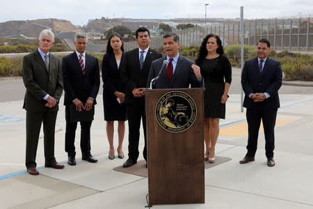 California Attorney General Xavier Becerra speaks next to the U.S. Mexico border to announce a lawsuit against the Trump Administration over its plan to begin construction of border wall projects in San Diego and Imperial Counties in San Diego, California, U.S. September 20, 2017. REUTERS/Mike Blake