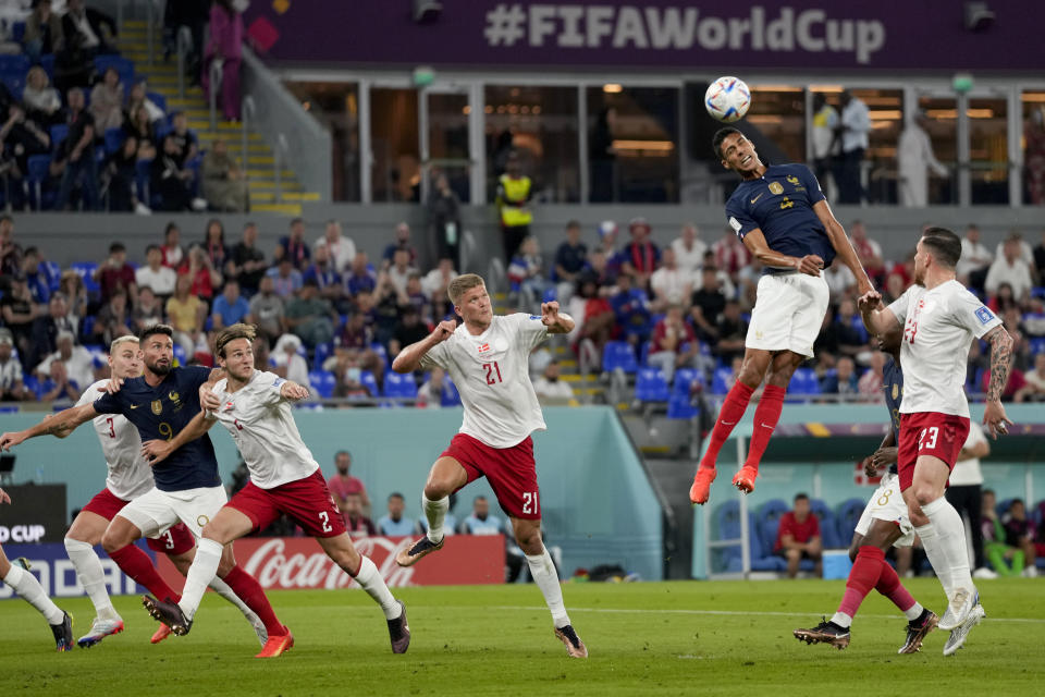 France's Raphael Varane, second right, goes for a header during the World Cup group D soccer match between France and Denmark, at the Stadium 974 in Doha, Qatar, Saturday, Nov. 26, 2022. (AP Photo/Frank Augstein)